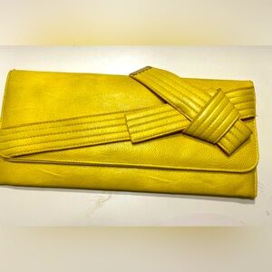 Jessica Simpson yellow clutch on a chain